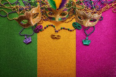 Mardi gras, Venetian or Carnivale mask on on a tricolor shining background