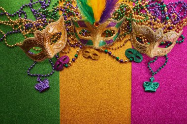 Mardi gras, Venetian or Carnivale mask on on a tricolor shining background