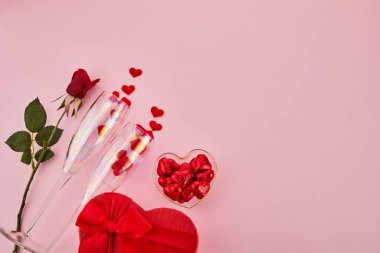 Valentines day framework with glasses and gift on gray background. View from above. Copy space