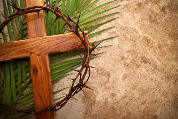 Crown of thorns, cross and palm leaves. Palm sunday and easter day concept