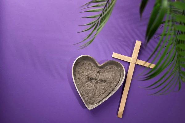 Ash Wednesday, Lent Season and Holy Week concept. Christian crosses and ashes on purple background