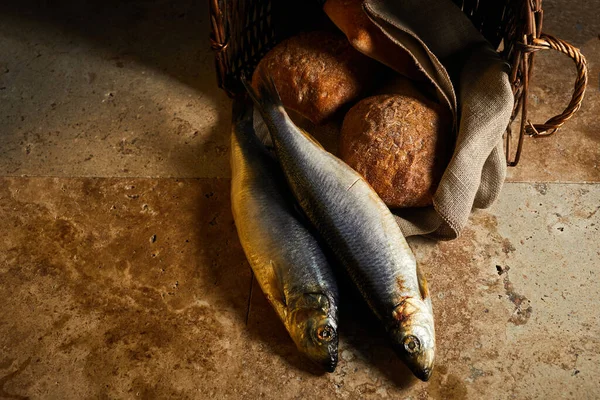 Christianity background. Loaves of bread and two fish in a basket