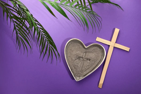 Ash Wednesday, Lent Season and Holy Week concept. Christian crosses and ashes on purple background
