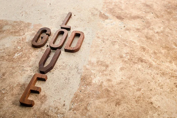 God is love concept text lying on the rustic travertine stone background