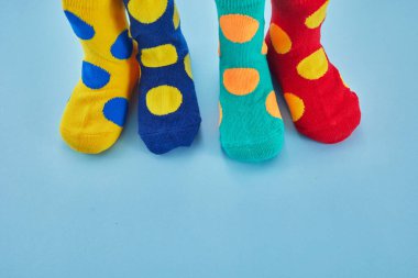 World Down syndrome day background. Down syndrome awareness concept. Legs with different socks as symbol of down syndrome.