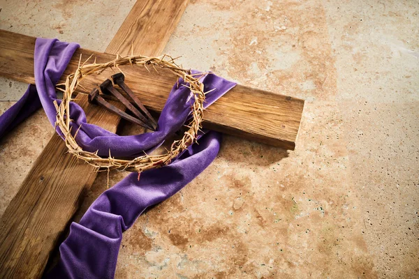 Lent season, Holy week and Good friday concept. Cross With three Nails And Crown Of Thorn on stone background.