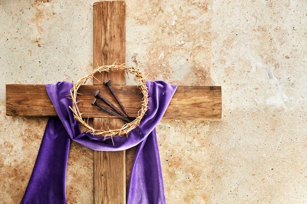 Lent season, Holy week and Good friday concept. Cross With three Nails And Crown Of Thorn on stone background.