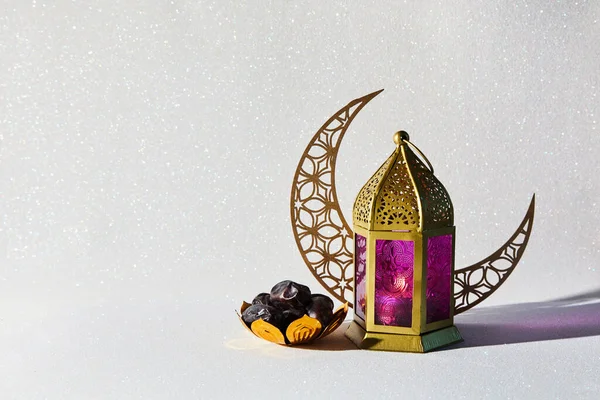 Muslim Holy Month Ramadan Kareem. Lantern, moon symbol and small plate of dates
