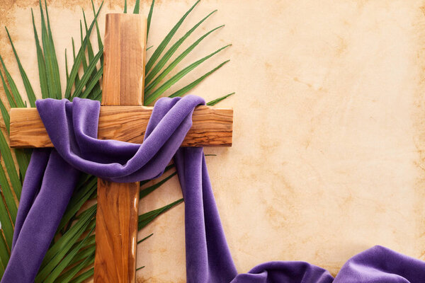 Palm sunday background. Cross and palm on vintage background