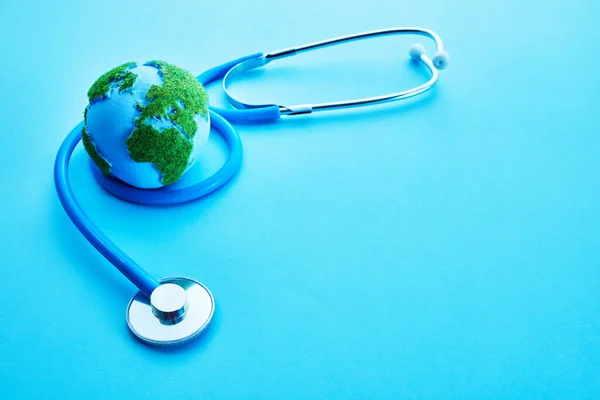 World Health Day. Global Health Awareness Concept. Globe and Stethoscope on blue background