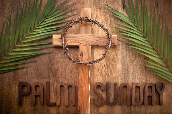 Palm sunday background. Cross and palm on vintage background