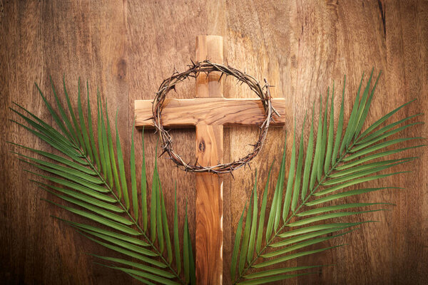 Palm sunday background. Cross and palm on vintage background