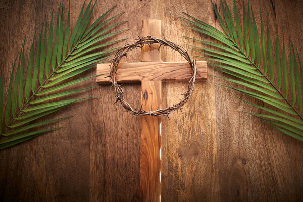 Palm sunday background. Cross and palm on vintage background
