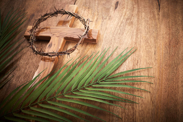 Palm sunday background. Cross and palm on vintage background