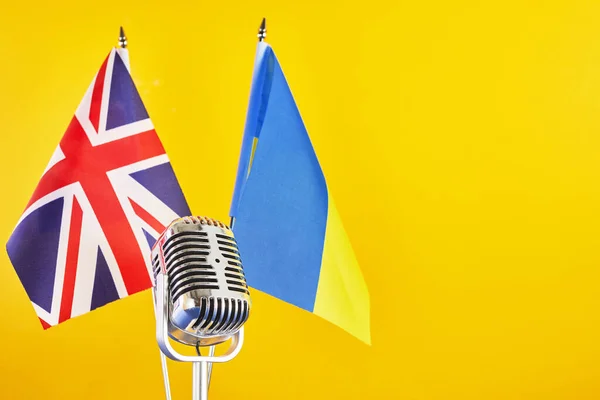 Microphone on a background of a blurry flags Ukraine and Great Britain. European Song Contest Liverpool