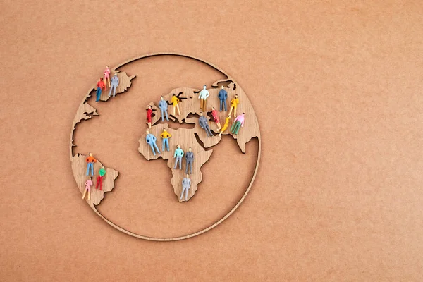 World Population Day, creative concept. Large and diverse group of people in the shape of the world map.