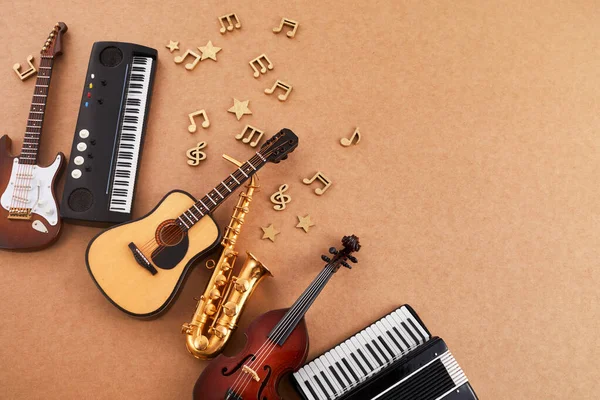Happy world music day. Musical instruments on brown background