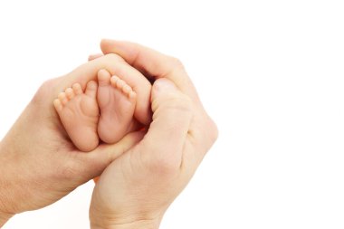 Dünya Prematüre Günü, 17 Kasım. Bebek ayaklı bir kadın eli. Annelik ve bakım