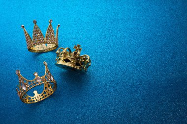 Epiphany Günü ya da Dia de Reyes Magos konsepti. Mavi parlak arka planda üç altın kaplama.
