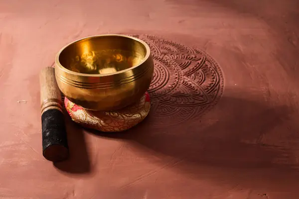 A close up of a tibetan singing bowl or himalayan bowl for therapy, meditation and relaxation