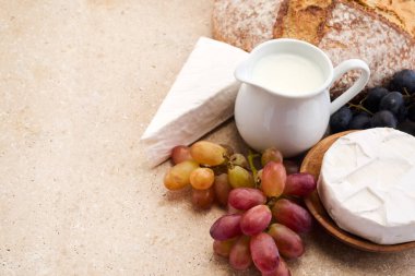 Yahudi bayramı Shavuot konsepti. Tohumlar, süt ve peynir Travertini taşından arka planda.
