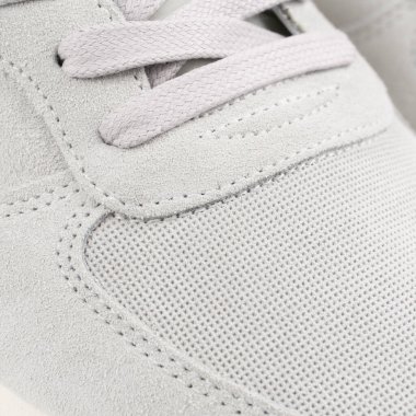 Lacing on the light grey sneaker close up