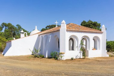 White walls and red tile roof of an old catholic church in Portugal