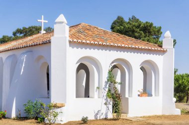 White walls and red tile roof of an old catholic church in Portugal