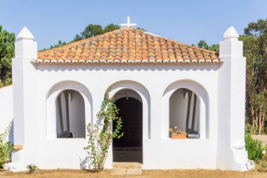 White walls and red tile roof of an old catholic church in Portugal