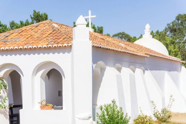 White walls and red tile roof of an old catholic church in Portugal