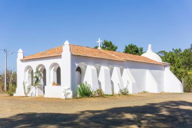 White walls and red tile roof of an old catholic church in Portugal