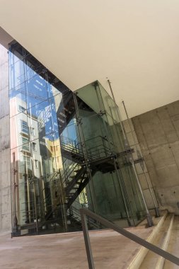 A glass stairwell with metal elements in a modern building