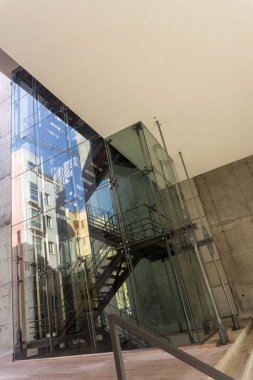 A glass stairwell with metal elements in a modern building