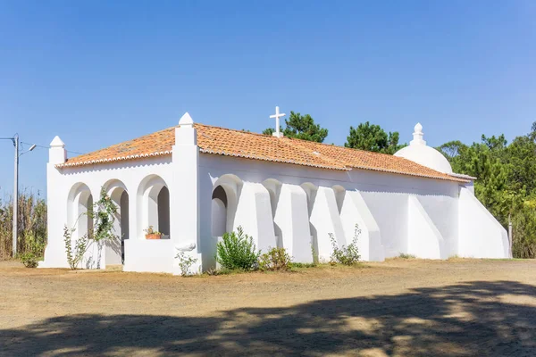 White walls and red tile roof of an old catholic church in Portugal