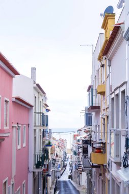 An empty old street leading to the ocean, in the historic center of the Portuguese city of Nazare