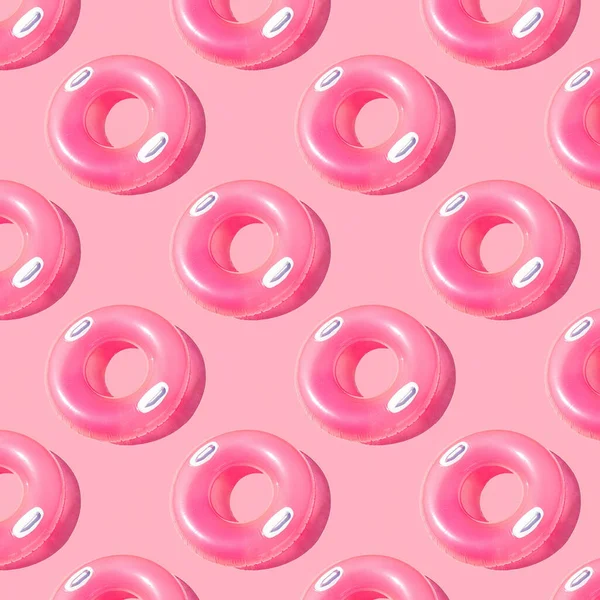Pattern of small bright pink inflatable rubber circles on a pale pink background