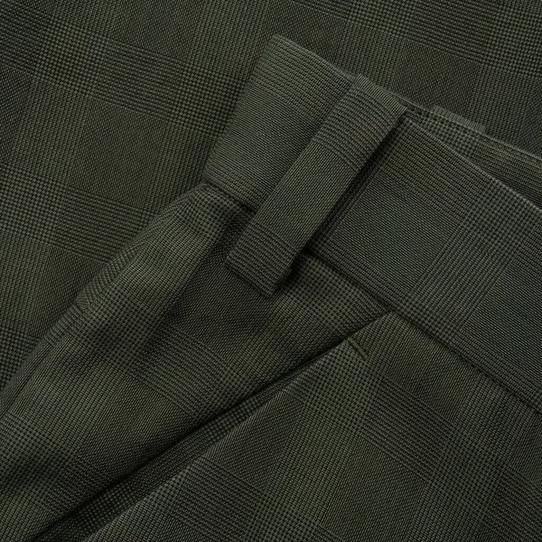 Detail of a checkered dark green trouser belt with loop and pocket close up