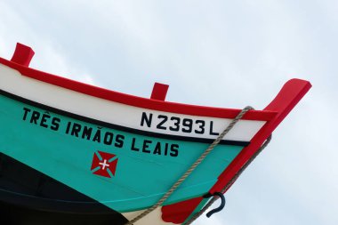 Traditional wooden portuguese fishing boat with oars in Nazare close up