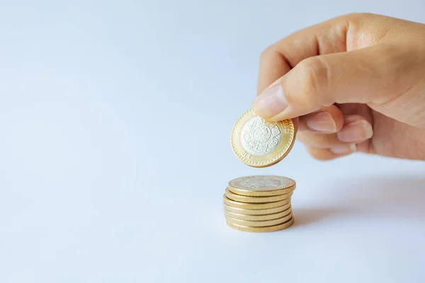 stock image Money in the hands of a woman. Coins of ten Mexican pesos. Savings and economy in Mexico