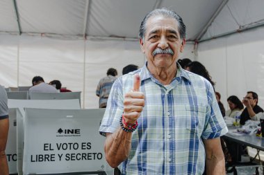 Puebla, Meksika 1 Haziran 2025. Vatandaşlar, ilk adli seçimlere katıldıklarını belirtmek için dövmeli başparmaklarını gururla kaldırıyorlar.. 