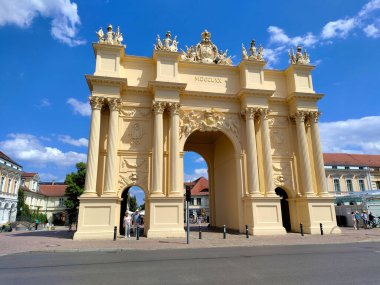 Potsdam, Germany - July 5, 2022: Reconstructed Brandenburg gate with beige facade on main Postdam square during a beautiful summer day. clipart