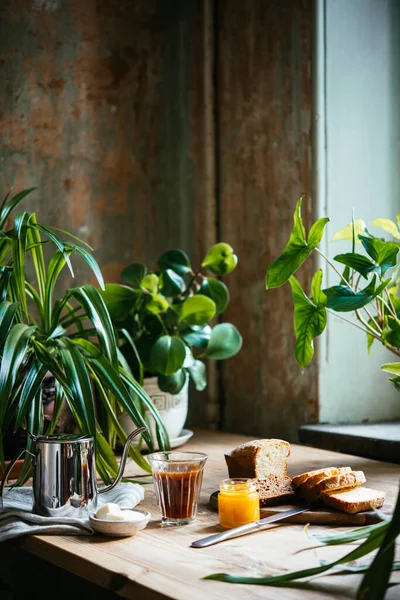 Πρωινό Κρουασάν Και Καφέ Σερβίρεται Ένα Όμορφο Τραπέζι Γεμάτο Φυτά — Φωτογραφία Αρχείου