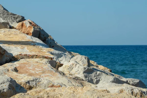 Rocky coast of the mediterranean sea in the Turkey. Blue sea and blue sky, without cloud