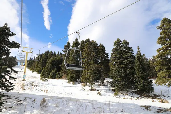Ski Lift snowy mountain winter forest with chair lift At The Ski Resort in winter. Snowy weather Ski holidays Winter sport and outdoor activities Outdoor tourism, Bursa (Turkey), Uludag ski lift