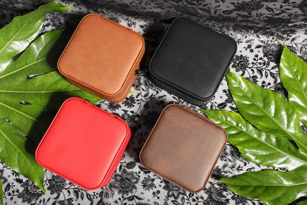 Diffirent colors leather jewelry box. Concept shot, top view. Custom background jewelry box view. Jewelry box and accessories.