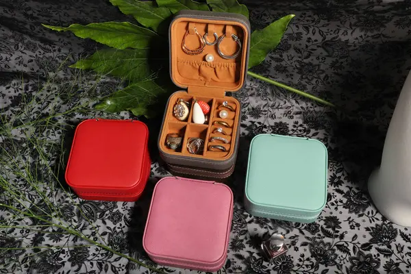 Diffirent colors leather jewelry box. Concept shot, top view. Custom background jewelry box view. Jewelry box and accessories.