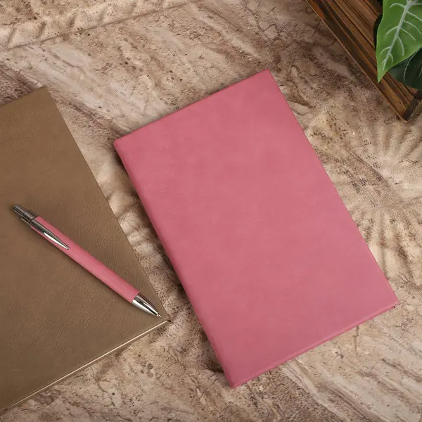 Leather Journals and Notebooks in pink colors. Concept shot, top view. Custom background Journals and Notebooks view. Leather Sketchbook. Space Blank for text