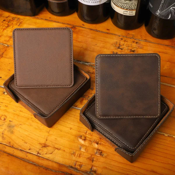 Leather table mats in different colors. Concept shot, top view. Custom background view of leather table coaster. Stitched and leather table coaster