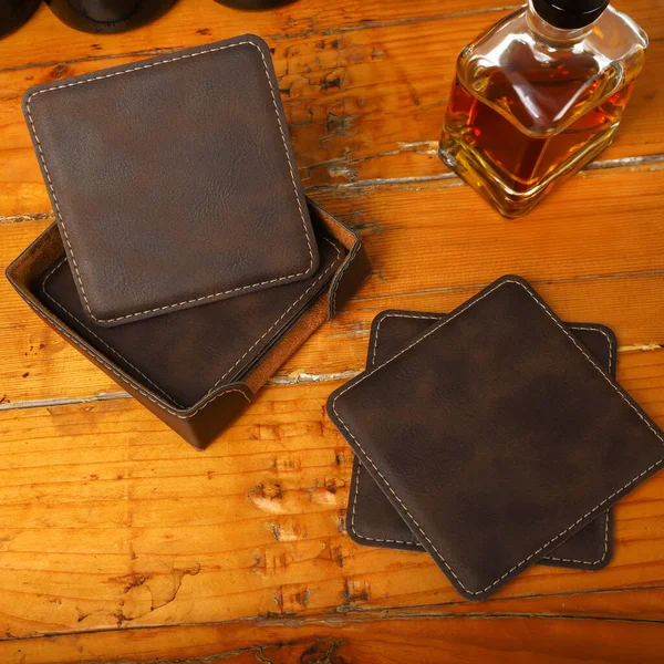 Leather table mats in different colors. Concept shot, top view. Custom background view of leather table coaster. Stitched and leather table coaster