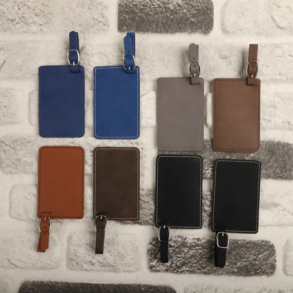 Leather luggage tags in different colors. Concept shot, top view. Custom background, luggage tags view. Empty Travel Luggage Label, Space blank for text.